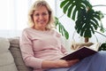 Fantastic madam smiling while reading book Royalty Free Stock Photo