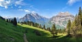 Fantastic morning mood in the mountains of glarus. Sun on the alp. View of an alpine hut in front of the big mountian Royalty Free Stock Photo