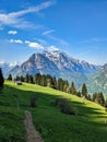 Fantastic morning mood in the mountains of glarus. Sun on the alp. View of an alpine hut in front of the big mountian Royalty Free Stock Photo