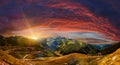 Fantastic mountain scenery. majestic sunset with dramatic sky. Colorful blooden clouds in the sky