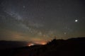 Fantastic mountains view at night. Fir-trees silhouettes against dark blue sky with sparkling stars Royalty Free Stock Photo