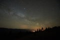 Fantastic mountains view at night. Fir-trees silhouettes against dark blue sky with sparkling stars Royalty Free Stock Photo