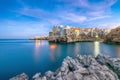 Fantastic night scene at Cala Paura gulf with Bastione di Santo Stefano in village on the rocks Polignano a Mare