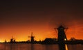 Fantastic orange sunset traditional Dutch windmills canal in Rot