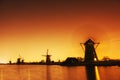 Fantastic orange sunset traditional Dutch windmills canal in Rot
