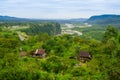 Fantastic overview of amazon jungle valley with river and waterfalls in the distance, some simple small houses located