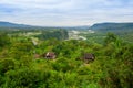 Fantastic overview of amazon jungle valley with river and waterfalls in the distance, some simple small houses located