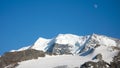 Fantastic panoramic mountain landscape and view of the Piz Palu near St. Moritz under a blue sky with moon