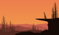 A fantastic panoramic view of the silhouettes of mountains and dry trees at dusk. Vector illustration