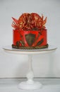 Fantastic red game of thrones cake with gilded decoration