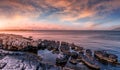 Fantastic rocky beach coastline during sunset. impressively beautiful seascape with picturesque sky over calm blue ocean under Royalty Free Stock Photo