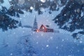 Fantastic scene with snowy house in evening forest. Royalty Free Stock Photo