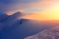 Fantastic scenery with a free rider and mountaineer, high mountains in snow and the fog with interesting colour from the sun. Royalty Free Stock Photo