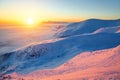 Fantastic scenery with the high mountains in snow, dense textured fog and a sunrise in the cold winter day. Royalty Free Stock Photo
