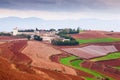 Fantastic scenery rural of south Yunnan, China. Beautiful wheat fields on the Red Land of Dongchuan. Two motorcycles on the road, Royalty Free Stock Photo