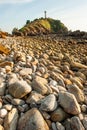 Fantastic scenery stone beach at sunset, mountain light house blurred backgrounds. Lanta Island, Thailand Royalty Free Stock Photo