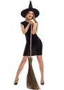 Attractive witch girl with a broom isolated on a white background. Halloween costumes concept.