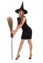 Attractive witch girl with a broom isolated on a white background. Halloween costumes concept.