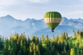 Fantastic snow-capped mountains in the beautiful cumulus clouds. A balloon in the background. Carpathians. Ukraine