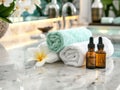 fantastic spa environment with rolled white and mint green towels, essential oil and exotic flowers Royalty Free Stock Photo