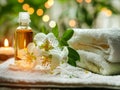 A fantastic spa environment with rolled white and mint green towels, essential oil and exotic flowers Royalty Free Stock Photo