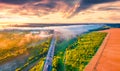 Fantastic summer sunrise on Ternopil outskirts with asphalt road. Royalty Free Stock Photo