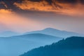 Fantastic sunrise above peaks of smoky mountain with the view into misty hills. Royalty Free Stock Photo
