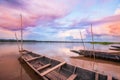Fantastic sunset sky over the Mekong River. Colorful clouds reflecting on a water, traditional thai fishing boat foregrounds. Royalty Free Stock Photo