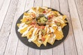 fantastic tray of nachos with Mexican guacamole, with lots of cheddar cheese and lots of cream cheese on top