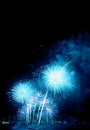 Fantastic vibrant blue fireworks splashing in the night sky over the harbor