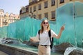 Fantastic view of the ancient homes on a sunny day. Woman with city map and smart phone. Gorgeous and picturesque scene