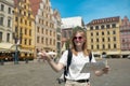 Fantastic view of the ancient homes on a sunny day. Woman with city map and smart phone. Gorgeous and picturesque scene