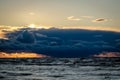 Dramatic and picturesque evening sunset scene over the sea. Storm passing, dramatic clouds after storm at sunset. Royalty Free Stock Photo