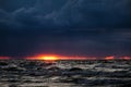 Dramatic and picturesque evening sunset scene over the sea. Storm passing, dramatic clouds after storm at sunset. Royalty Free Stock Photo