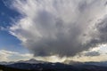 Fantastic view of huge white dark foreboding stormy cloud covering blue sky low over mountains Hoverla and Petros in Carpathian m Royalty Free Stock Photo