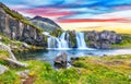 Fantastic view on Kirkjufellsfoss waterfall near Kirkjufell mountain at sunset