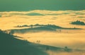 Fantastic view of the tops of the mountain ridge above the clouds Royalty Free Stock Photo