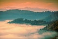 Fantastic view of the tops of the mountain ridge above the clouds Royalty Free Stock Photo
