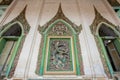 Fantastic on the wall the stucco tracery of Narayana bends his bow on giant, a character from the Ramayana epic. Wat Damrey Sor,