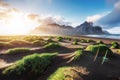 Fantastic west of the mountains and volcanic lava sand dunes on the beach Stokksness, Iceland. Colorful summer morning