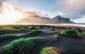 Fantastic west of the mountains and volcanic lava sand dunes on the beach Stokksness, Iceland. Colorful summer morning