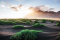 Fantastic west of the mountains and volcanic lava sand dunes on the beach Stokksness, Iceland. Colorful summer morning