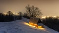 Fantastic winter landscape with glowing wooden house Royalty Free Stock Photo