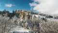 Fantastic winter landscape of high mountain and snowy forest on cloudy, blue sky background. Shot. Sunny day in white Royalty Free Stock Photo