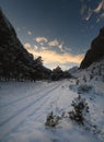 Fantastic winter landscape during sunset with colorful cloudy sky. Dramatic winter scene, snow-covered trees. Gorgeous Royalty Free Stock Photo