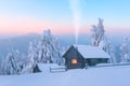 Fantastic winter landscape with wooden house in snowy mountains Royalty Free Stock Photo