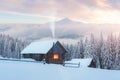 Fantastic winter landscape with wooden house in snowy mountains Royalty Free Stock Photo