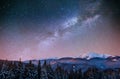 Fantastic winter meteor shower and the snow-capped mountains. Ca Royalty Free Stock Photo