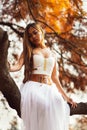 Fantastic young woman. beautiful fantasy girl fairy with white long dress in windy autumn park Royalty Free Stock Photo