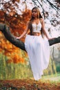 Fantastic young woman. beautiful fantasy girl fairy with white long dress in windy autumn park Royalty Free Stock Photo